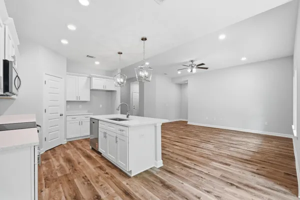 a kitchen with a stove a sink and a refrigerator