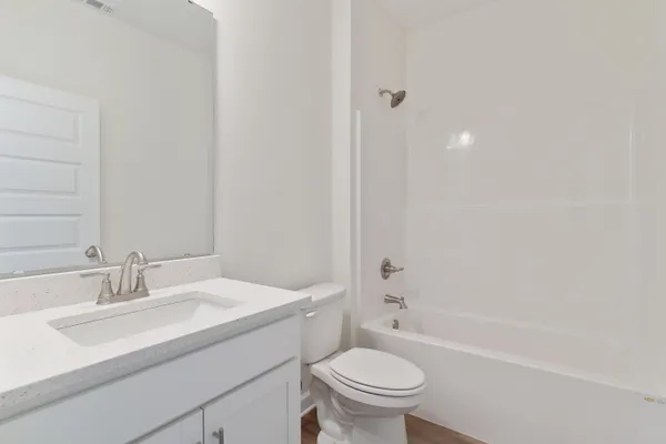 a bathroom with a sink toilet vanity and bathtub