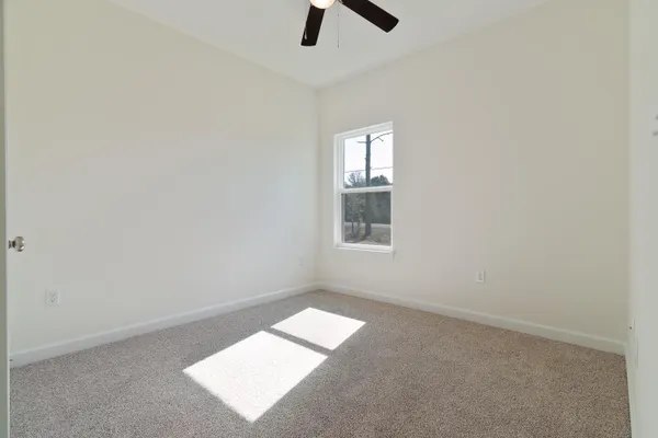 an empty room with windows and entrance