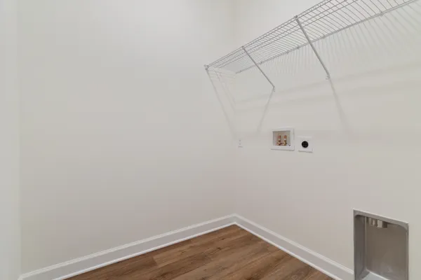 a view of a room with wooden floor