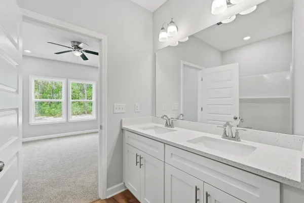 a bathroom with a sink a light fixture and a window