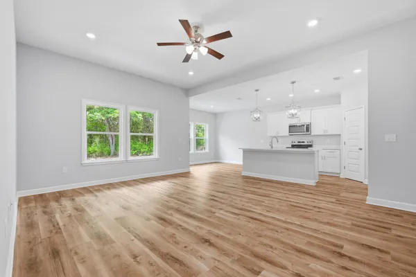 a view of kitchen with granite countertop cabinets and wooden floor