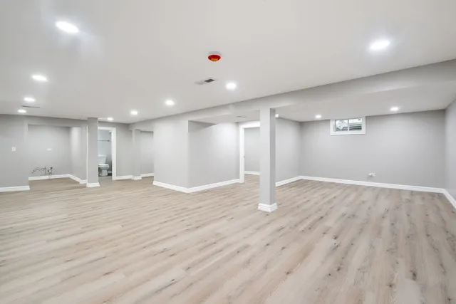 a bathroom with a toilet a sink and mirror