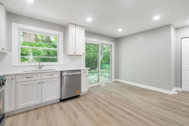 a kitchen with a sink and large window