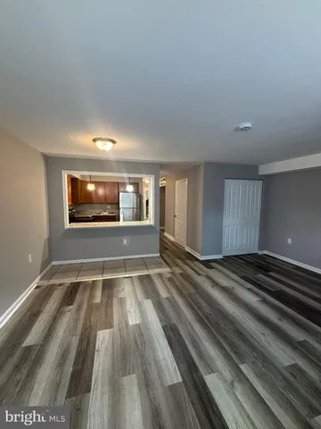 a view of empty room with window and fireplace