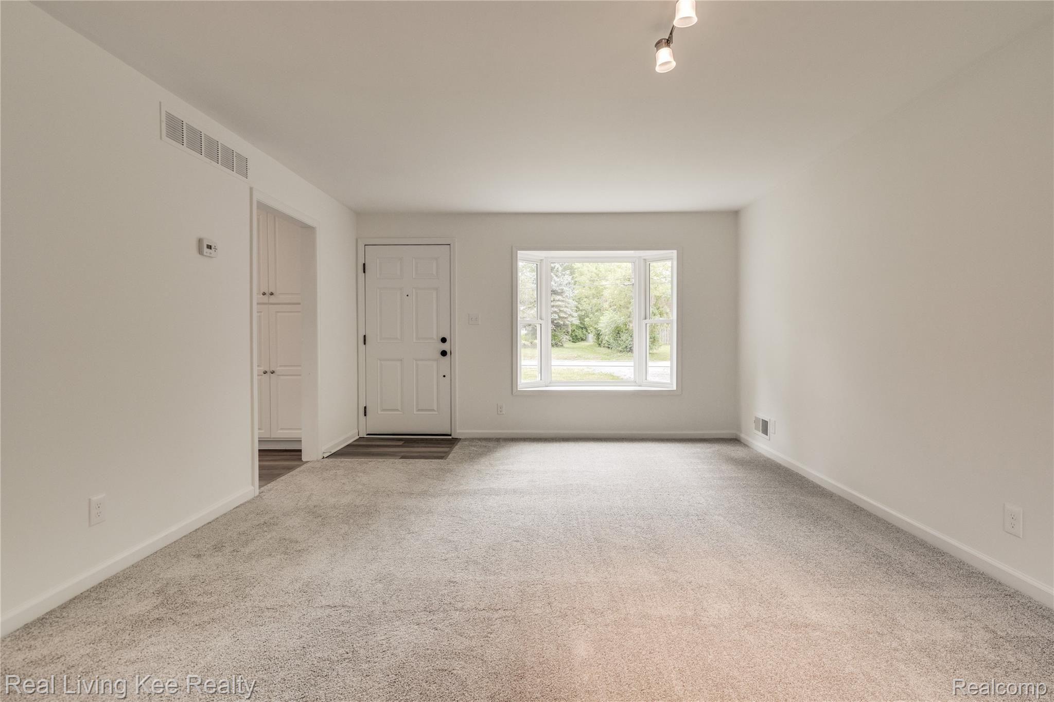 1928 Tamm Avenue Rochester, MI 48309 - Photo 7 of 41 Front Door & Living Room with Brand-New Carpeting & Bay Window
