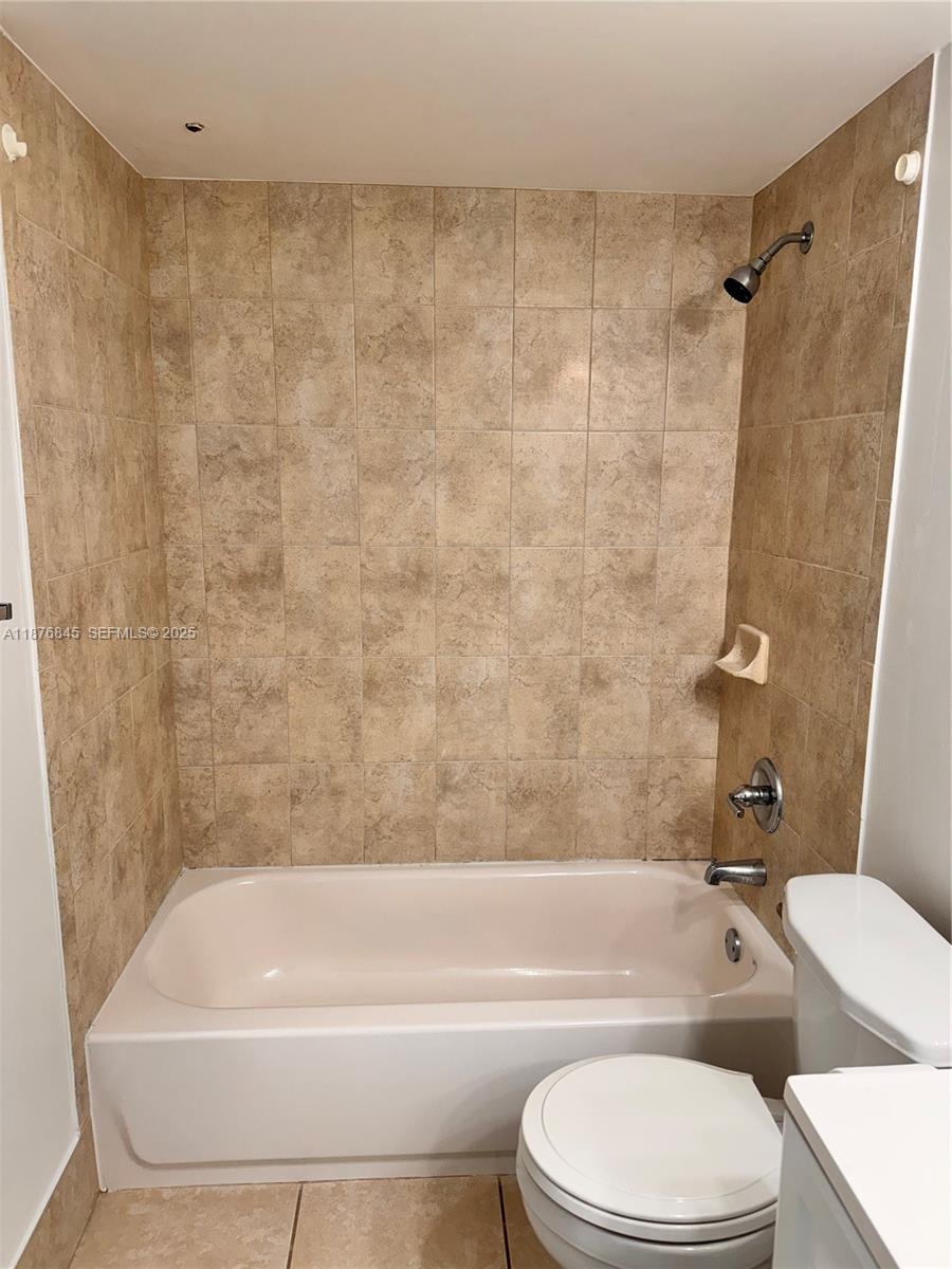 13355 Southwest 9th Court, Unit 310H Pembroke Pines, FL 33027 - Photo 12 of 30 a bathroom with a toilet a sink and bathtub