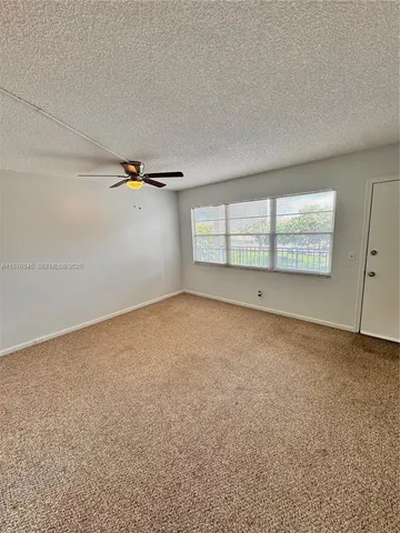 an empty room with a empty space and windows