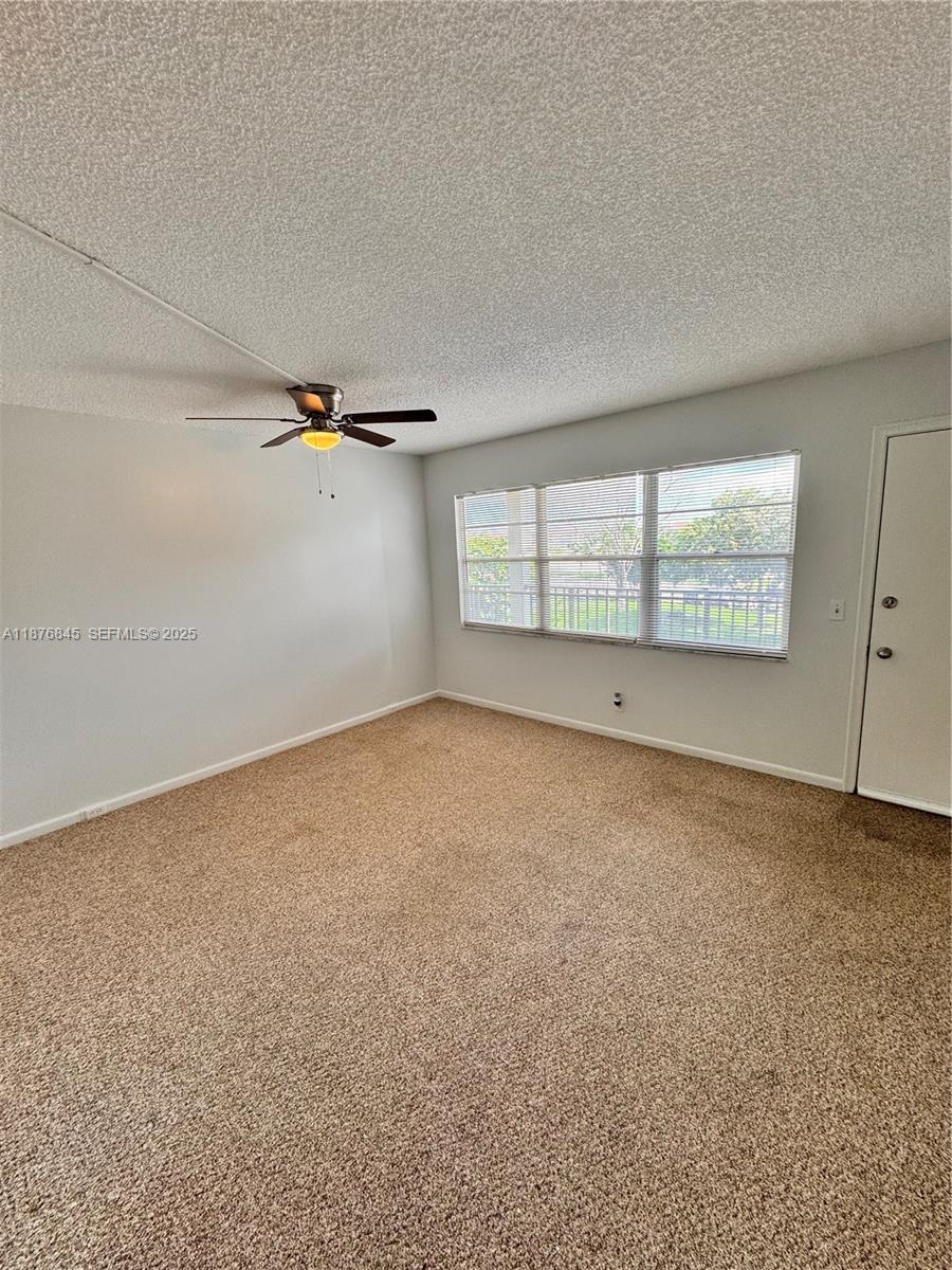 13355 Southwest 9th Court, Unit 310H Pembroke Pines, FL 33027 - Photo 13 of 30 an empty room with a empty space and windows