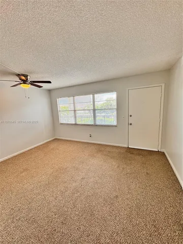 an empty room with a empty space and windows