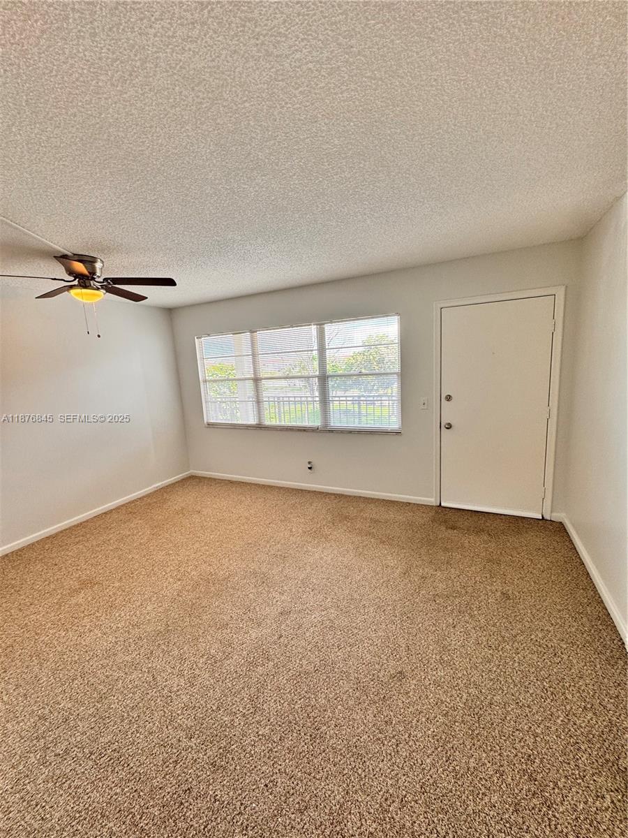 13355 Southwest 9th Court, Unit 310H Pembroke Pines, FL 33027 - Photo 14 of 30 an empty room with a empty space and windows