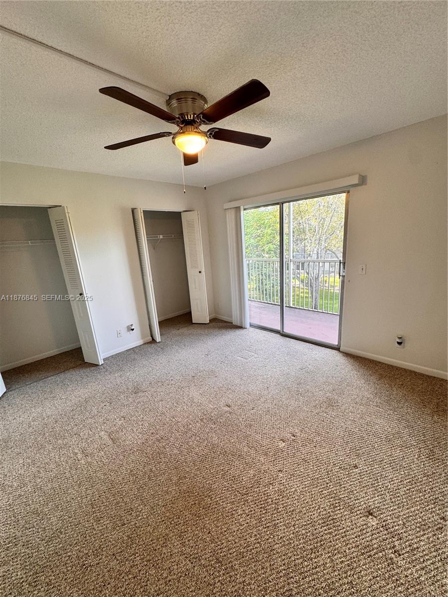 13355 Southwest 9th Court, Unit 310H Pembroke Pines, FL 33027 - Photo 16 of 30 a view of a livingroom with an empty space and a ceiling fan