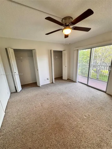 a view of a livingroom with a ceiling fan and window