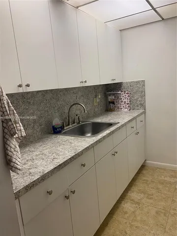 a kitchen with a sink and cabinets