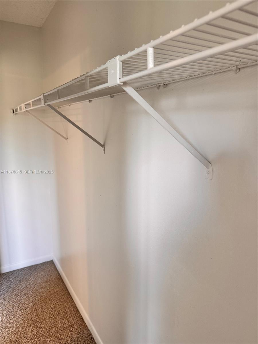 13355 Southwest 9th Court, Unit 310H Pembroke Pines, FL 33027 - Photo 22 of 30 a view of an empty walk in closet