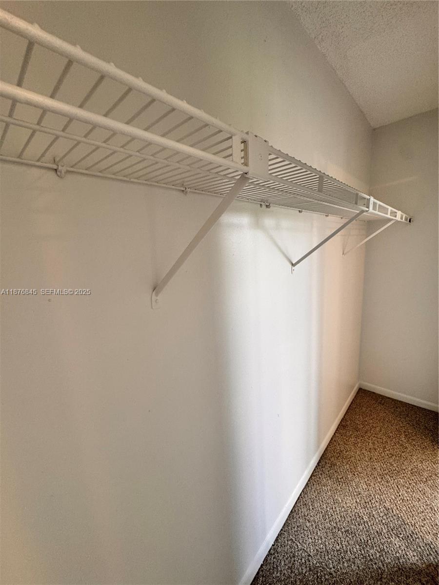 13355 Southwest 9th Court, Unit 310H Pembroke Pines, FL 33027 - Photo 23 of 30 a view of a room with racks on the wall