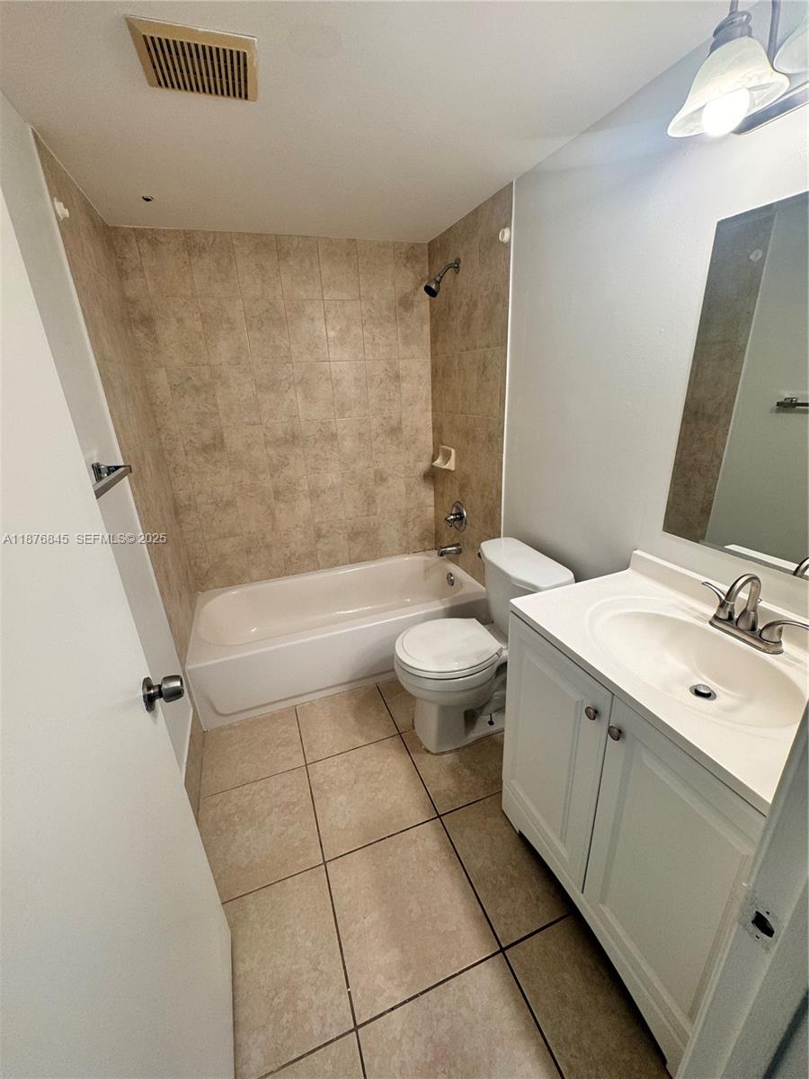 13355 Southwest 9th Court, Unit 310H Pembroke Pines, FL 33027 - Photo 3 of 30 a bathroom with a sink a toilet and shower