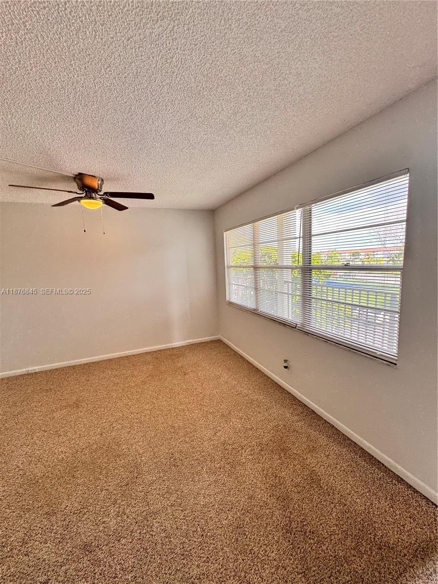 13355 Southwest 9th Court, Unit 310H Pembroke Pines, FL 33027 - Photo 9 of 30 a view of an empty room with a window