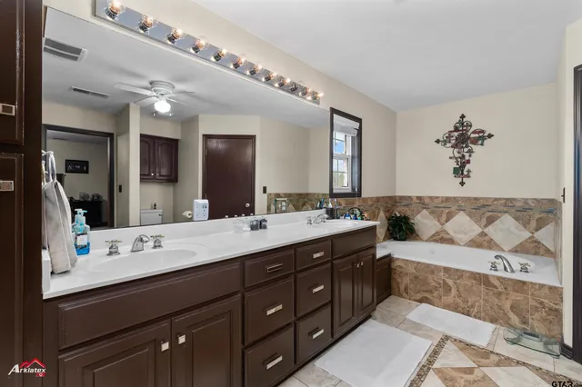 a bathroom with a sink double vanity and a mirror