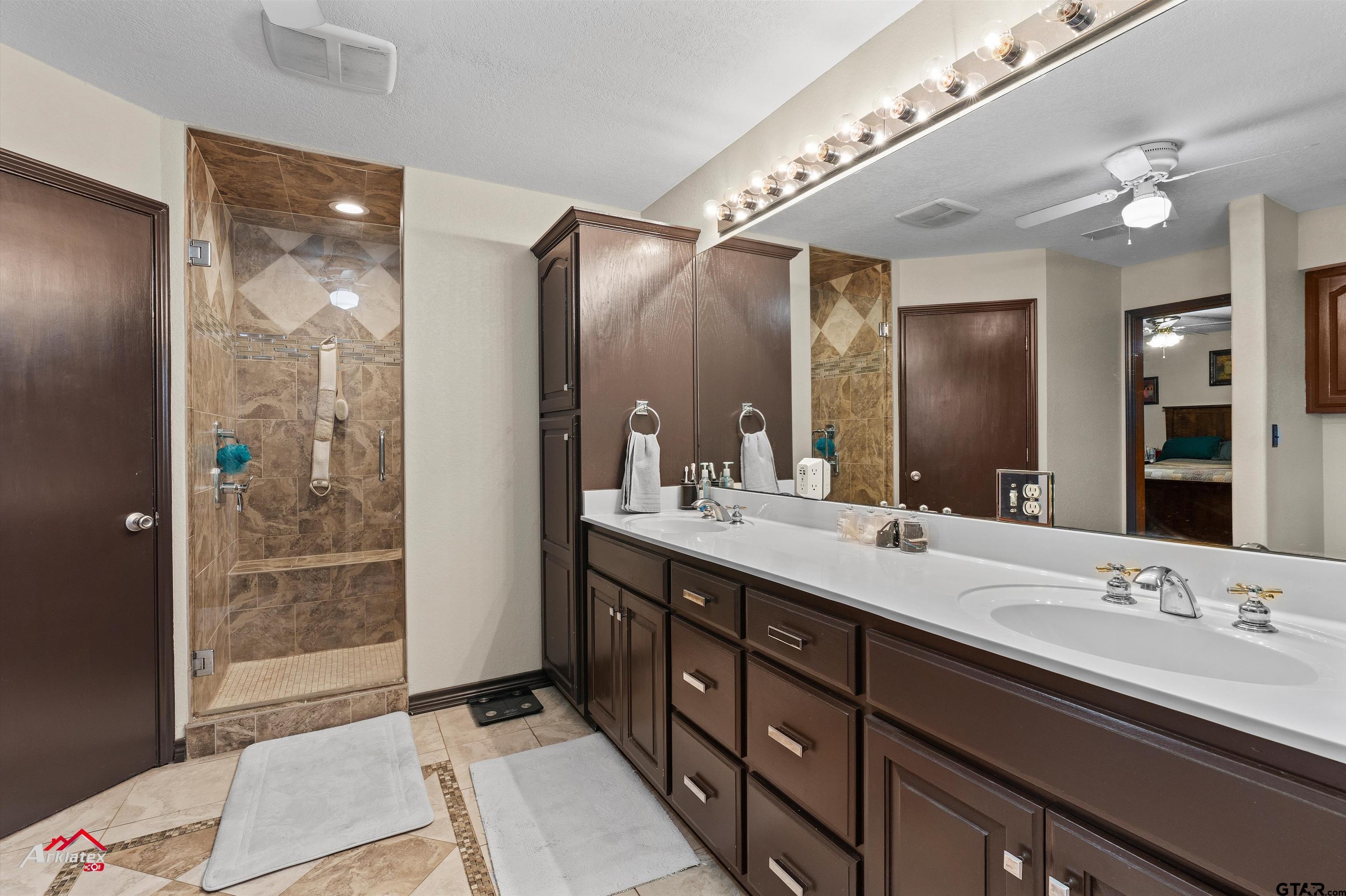 2150 County Road 121 Gary, TX 75643 - Photo 12 of 35 a bathroom with a double vanity sink and a mirror