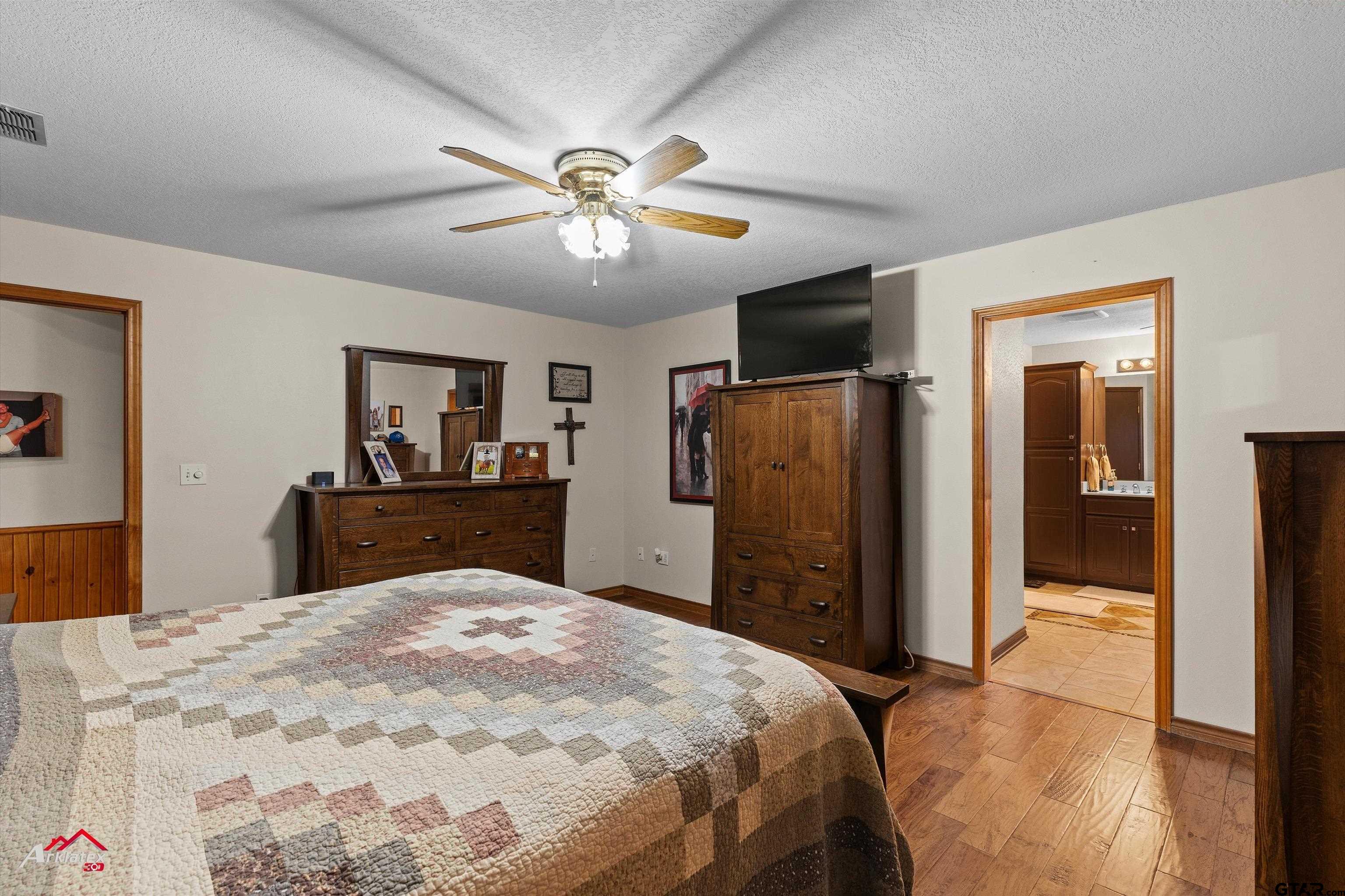 2150 County Road 121 Gary, TX 75643 - Photo 13 of 35 a bedroom with a bed and a chandelier