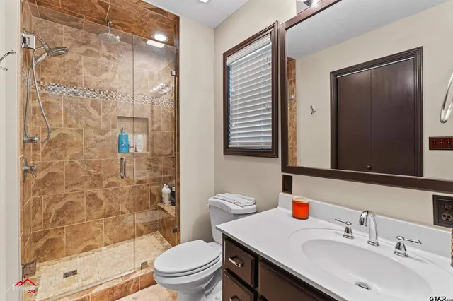 a bathroom with a sink toilet and shower