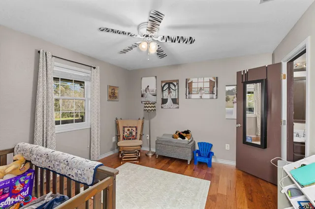 a bedroom with furniture and wooden floor