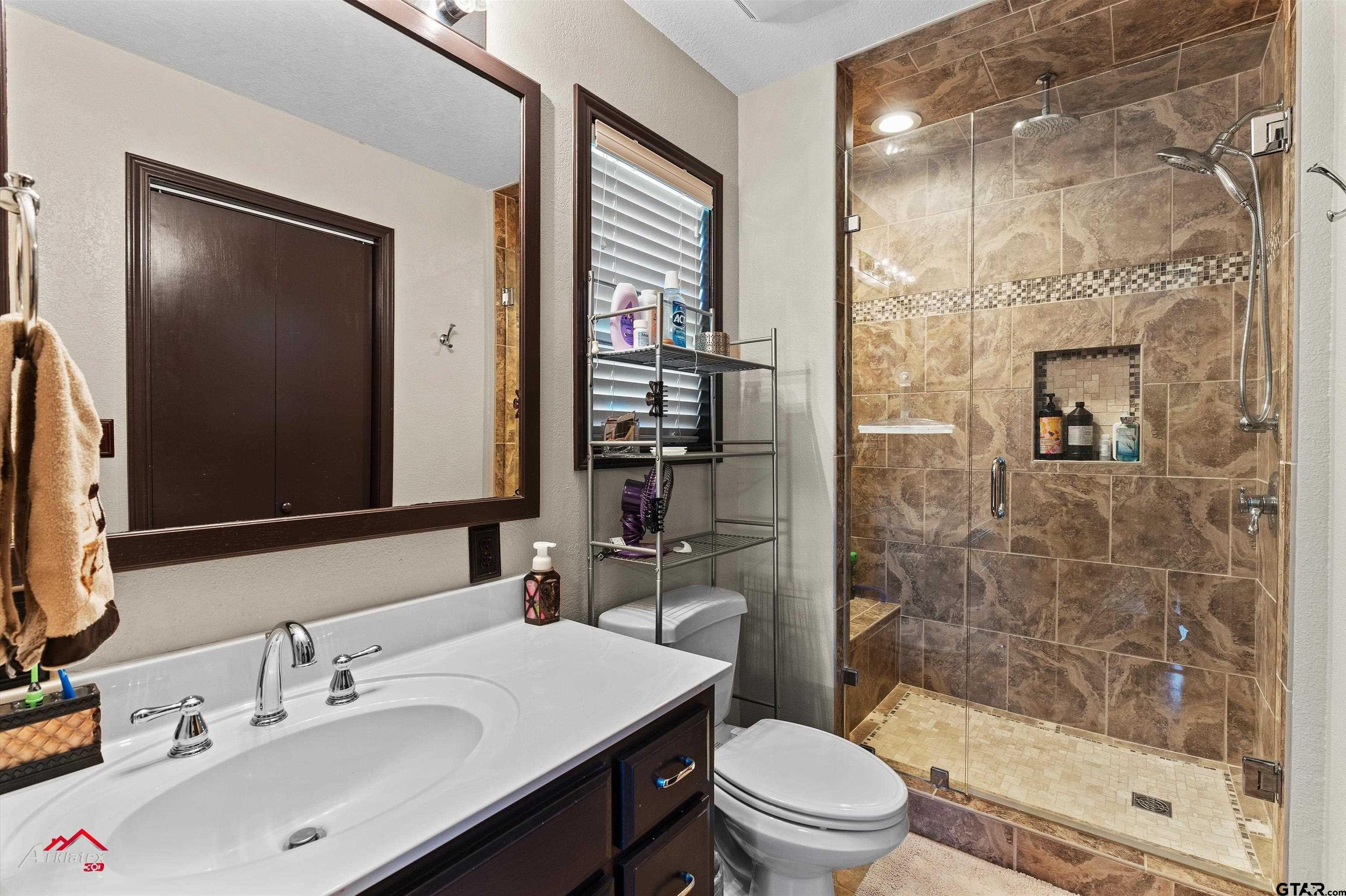 2150 County Road 121 Gary, TX 75643 - Photo 17 of 35 a bathroom with a sink a toilet and shower