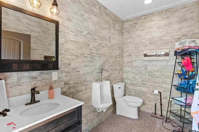 a bathroom with a toilet a sink and mirror