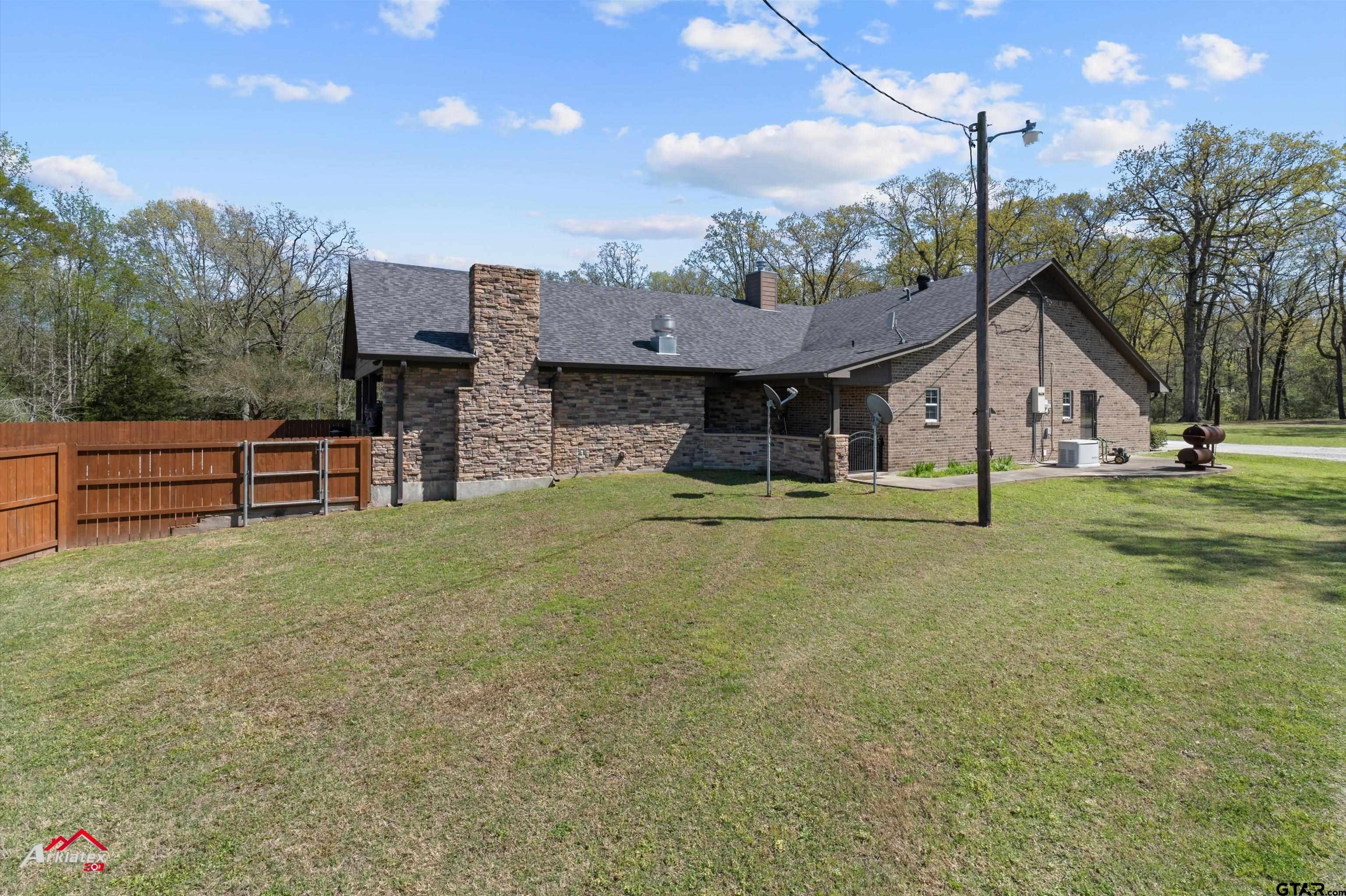 2150 County Road 121 Gary, TX 75643 - Photo 2 of 35 a front view of a house with garden