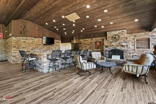 a living room with lots of furniture and a wooden floor