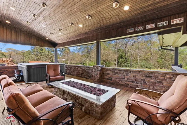 a living room with furniture a large window with outer view