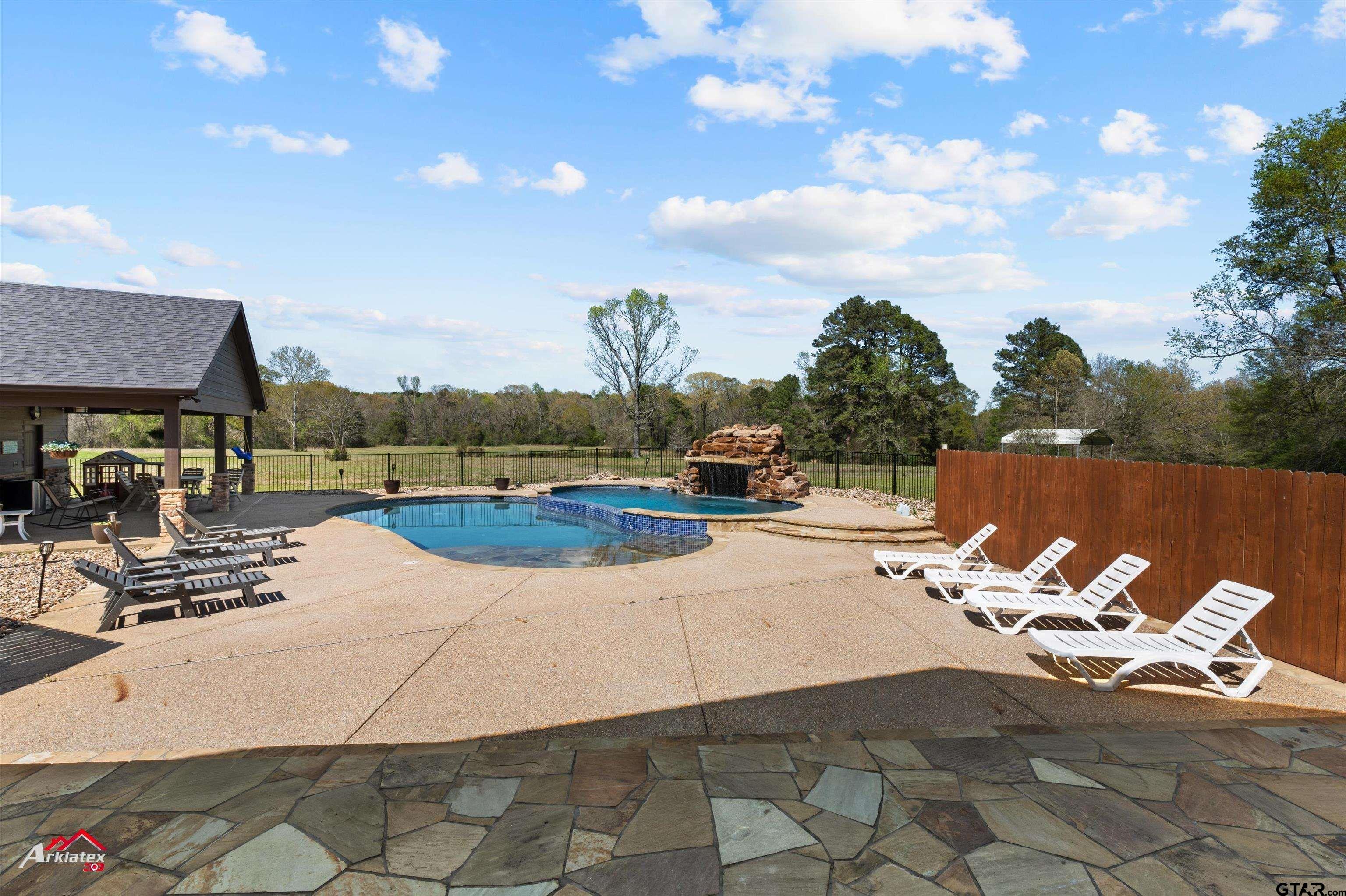 2150 County Road 121 Gary, TX 75643 - Photo 25 of 35 a view of a patio with chairs and umbrellas on a patio