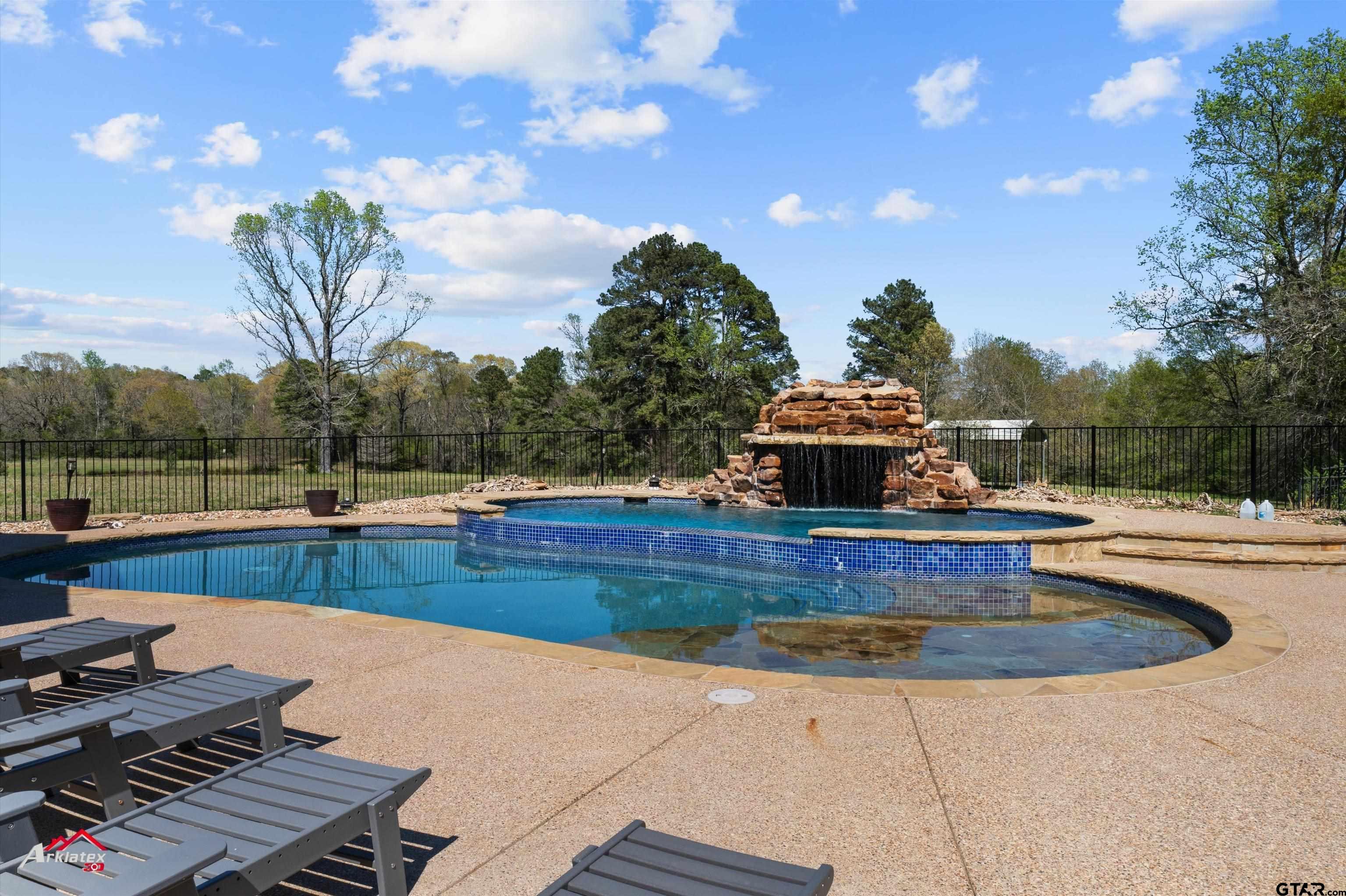 2150 County Road 121 Gary, TX 75643 - Photo 26 of 35 a view of a swimming pool with a patio