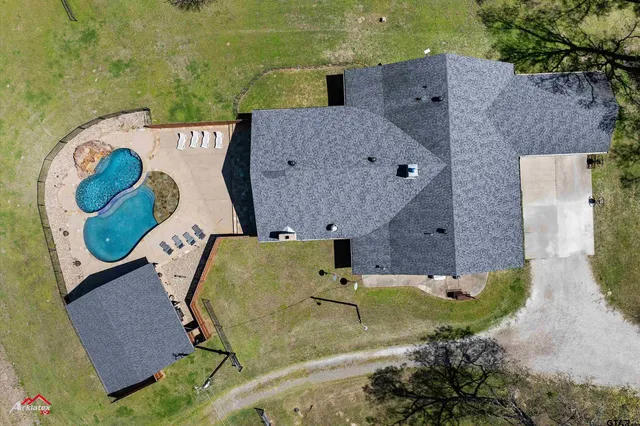an aerial view of a house with garden space and a outdoor space