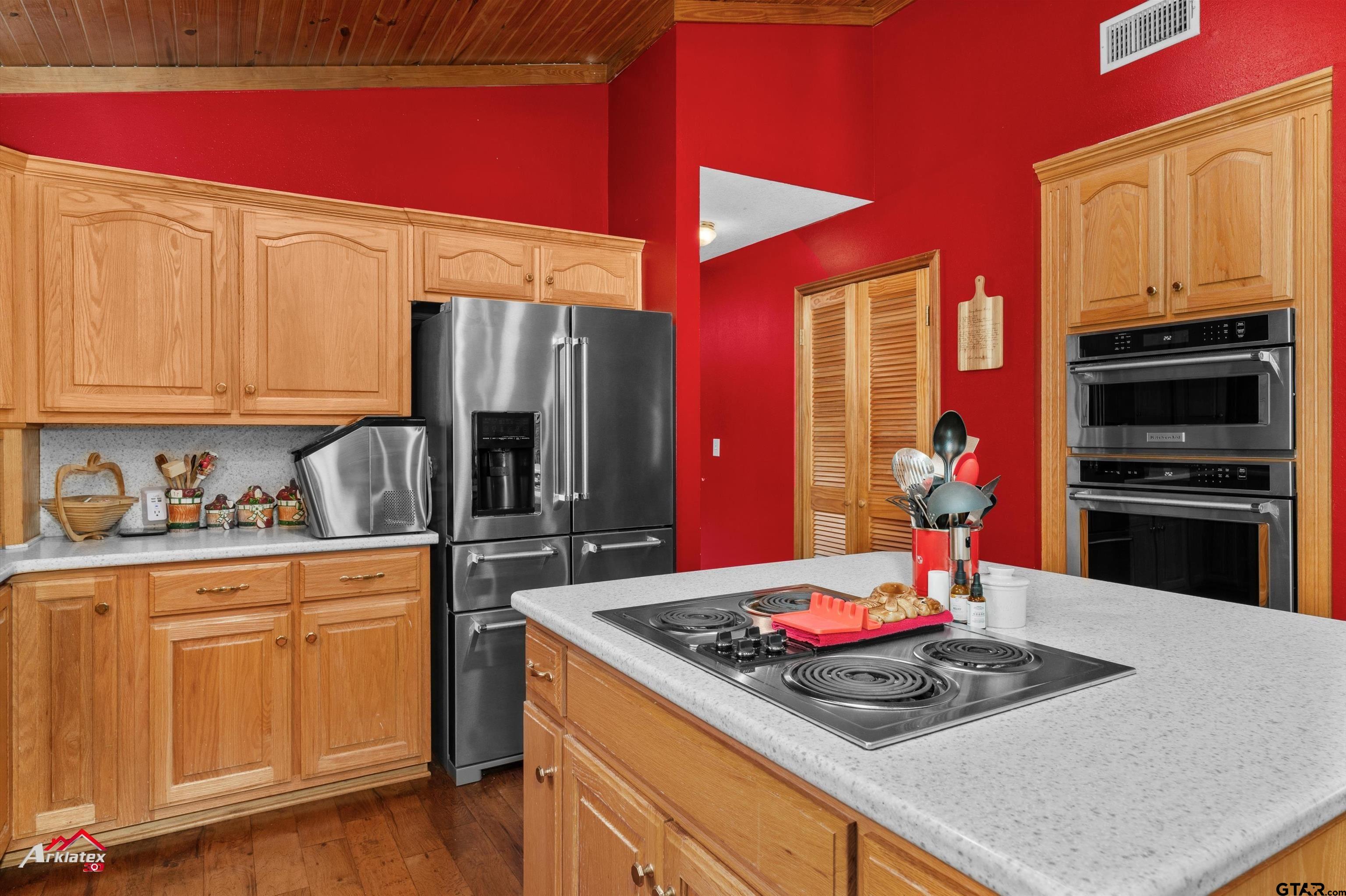 2150 County Road 121 Gary, TX 75643 - Photo 8 of 35 a kitchen with stainless steel appliances granite countertop a stove refrigerator and cabinets