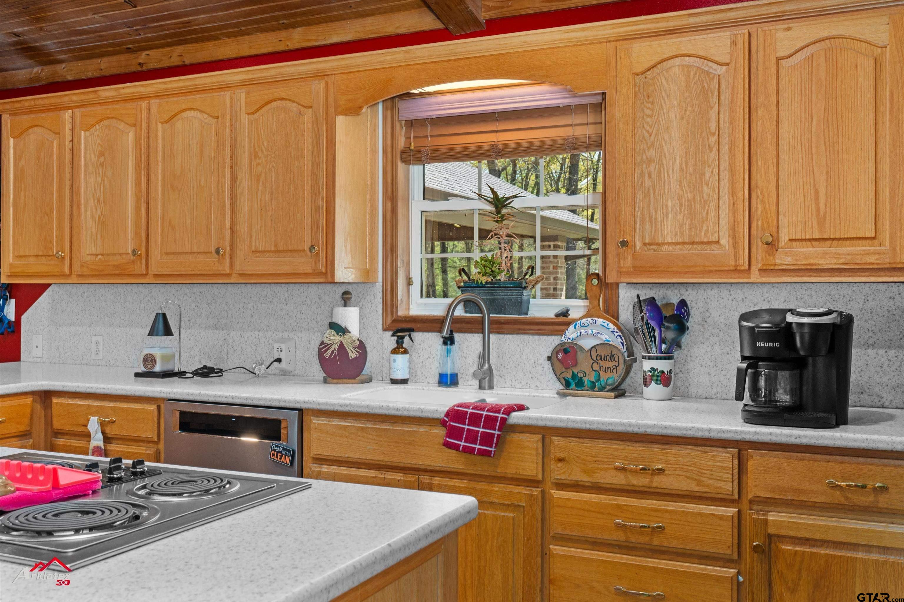 2150 County Road 121 Gary, TX 75643 - Photo 9 of 35 a kitchen with stainless steel appliances granite countertop a sink stove and cabinets