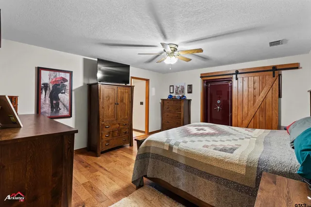 a bedroom with a bed and a flat tv screen