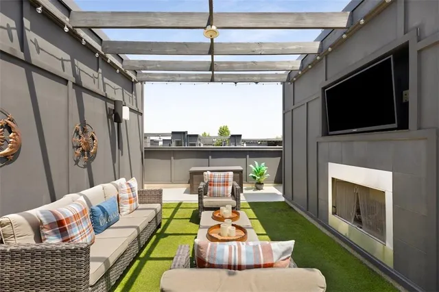 a living room with furniture fireplace and flat screen tv