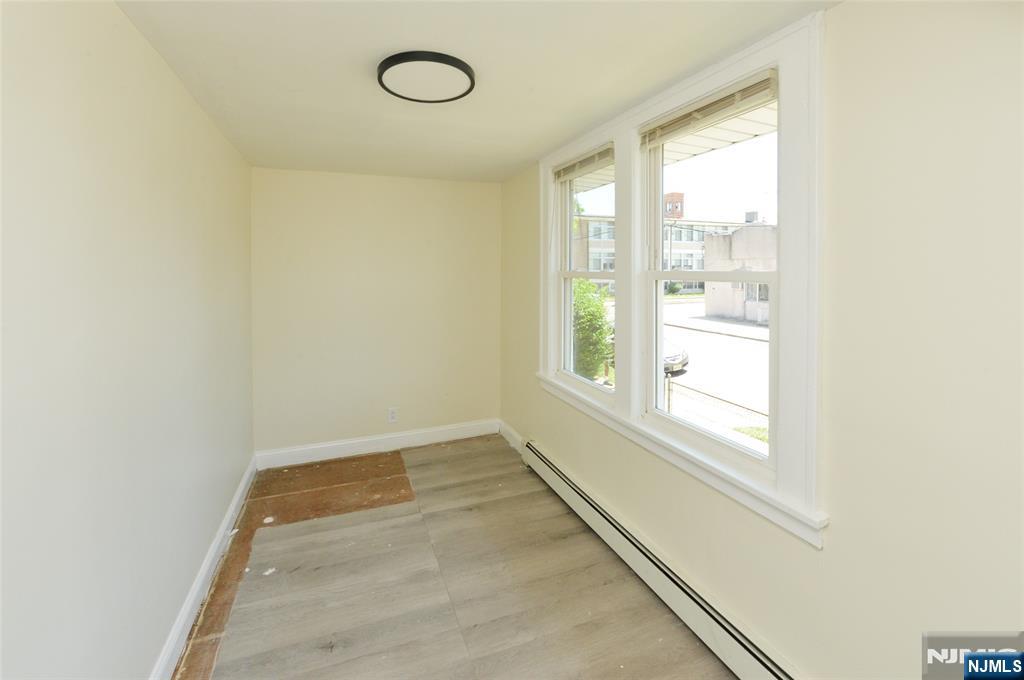 62 Broadway, Unit 1 Hackensack, NJ 07601 - Photo 5 of 25 an empty room with a window