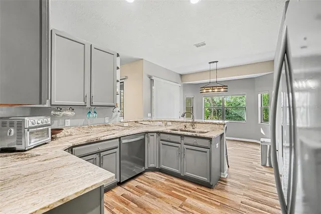 a kitchen with stainless steel appliances a stove sink and refrigerator