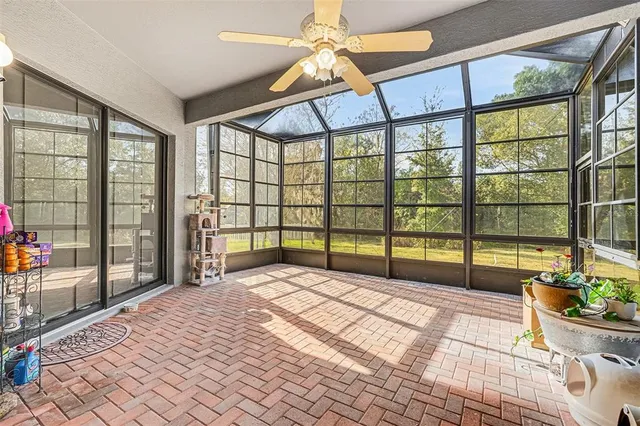 a bedroom with a bed and a large window with outer view