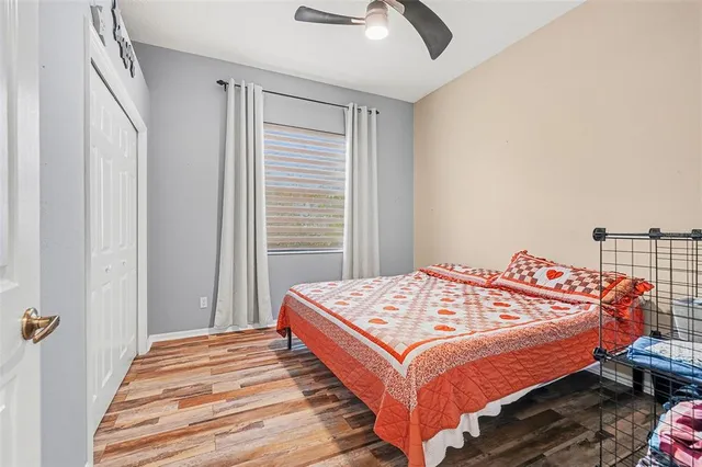 a bed sitting in a bedroom next to a window with a dresser