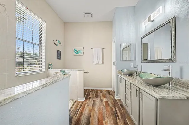 a bathroom with a granite countertop sink a toilet and a mirror