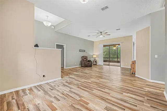 a view of a bedroom with wooden floor and a window