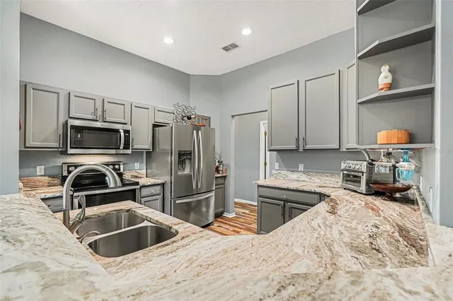 a kitchen with a sink stove and wooden cabinets