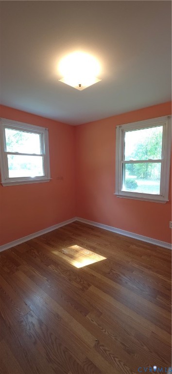 2519 Buckner Road Bumpass, VA 23024 - Photo 11 of 13 an empty room with wooden floor and windows