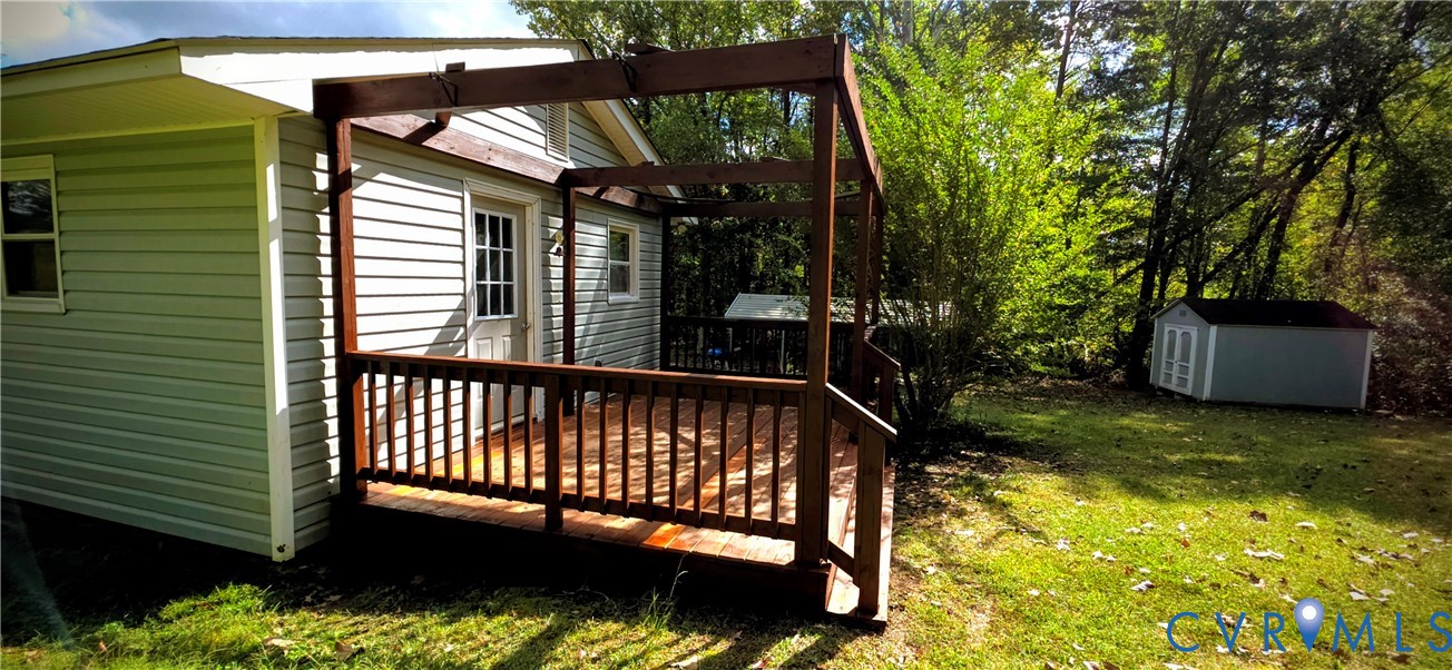 2519 Buckner Road Bumpass, VA 23024 - Photo 3 of 13 a view of a backyard with a large tree
