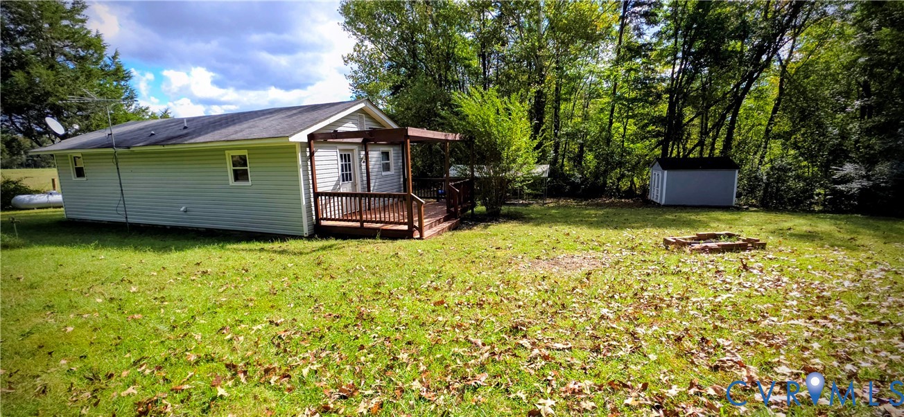 2519 Buckner Road Bumpass, VA 23024 - Photo 4 of 13 a view of a back yard with a wooden fence