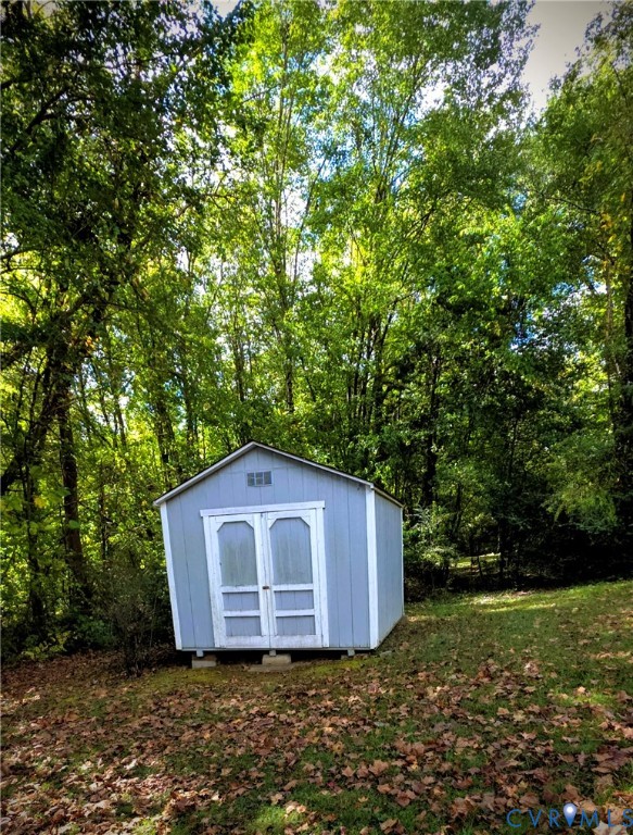 2519 Buckner Road Bumpass, VA 23024 - Photo 5 of 13 a house with trees in front of it